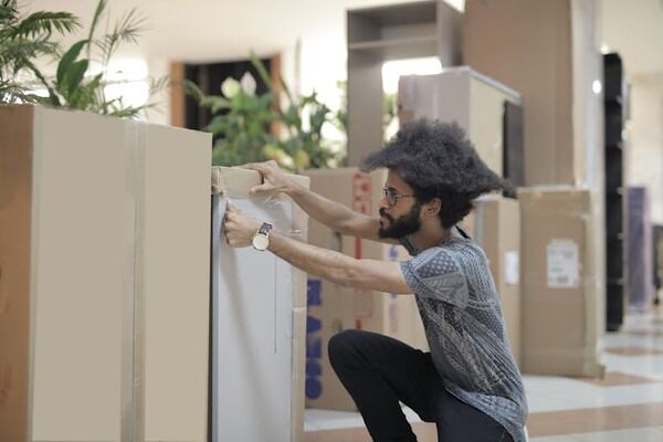 a man packing boxes for office relocation