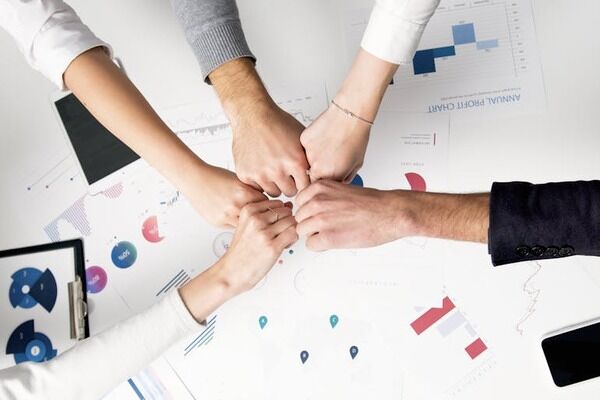 a close-up of people’s hands in the office