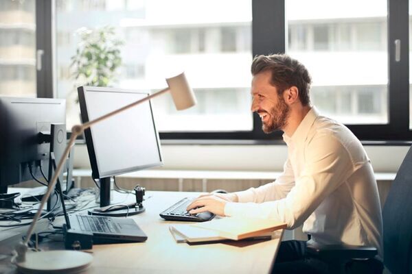 A man working in his office while smiling