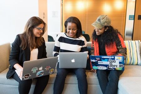 Three women with laptops searching for ways to create a culture of learning at work