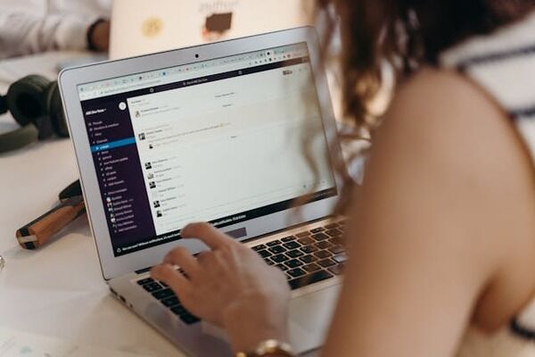 Woman using Slack app on her laptop