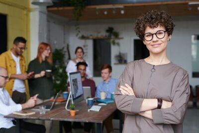 a happy team and a smiling leader with soft skills that are essential for great leaders