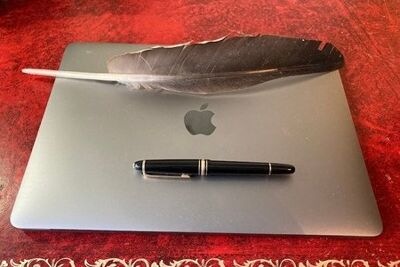 Laptop, pen and quill