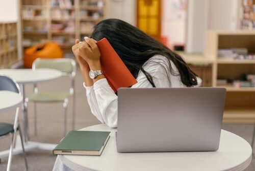 https://www.pexels.com/photo/shallow-focus-photo-of-woman-covering-her-face-with-a-notebook-9159061/