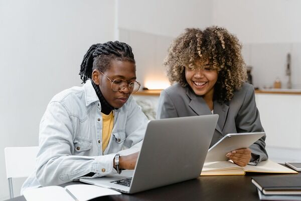 Two people having a conversation in an office.