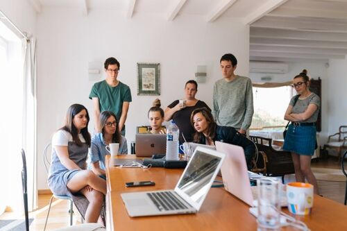 People reading and discussing signs of job-related stress in an office.