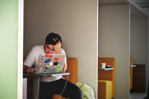 A man working while stressed.