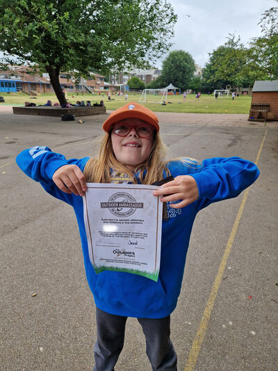 The Outdoors Project | Boy holding up Outdoors Ambassador certificate