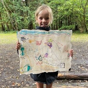 The Outdoors Project - girl with treasure map in nature