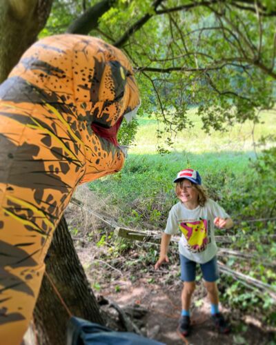 kid playing with dino the outdoors project