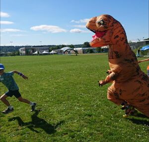 kid playing with dinosaur the outdoors project